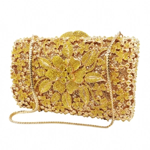 Detail of yellow crystal evening clutch with hollow metal floral pattern and gold chain