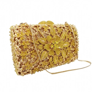 Close-up of golden floral evening clutch featuring intricate yellow rhinestones and chain