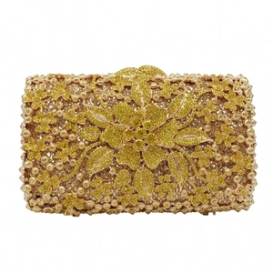 Detailed macro view of the gold rhinestone evening clutch featuring a 3D floral pattern