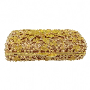 Detailed macro of golden hard shell evening clutch with luxury yellow rhinestones and floral clasp