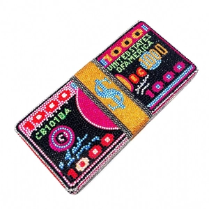 Macro view of crystal rhinestones on dollar bill stack evening clutch bag