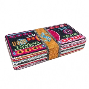 Detailed close-up of a luxury dollar-stack clutch with sparkling multi-colored rhinestones