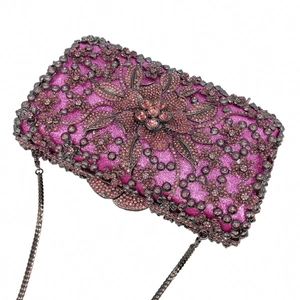 Detail of rose pink evening clutch with crystals, floral pattern and metal chain