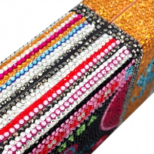 Macro detail of high-density colorful rhinestones on a luxury dollars shaped evening bag