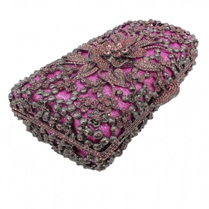 Macro view of floral hollow metal frame and pink rhinestones on a rectangle evening clutch