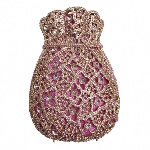 Detail of pink crystal drawstring evening bag with ornate gold filigree floral pattern
