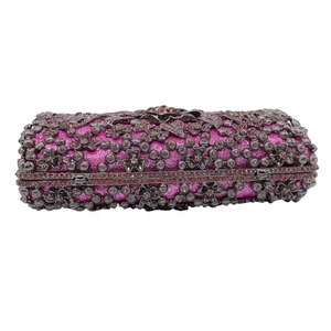 Detail of luxury purple evening clutch with black floral metal hollow and rhinestones