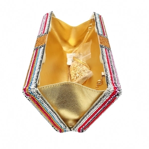 Detailed interior view of a colorful rhinestone money clutch bag with a golden metal chain