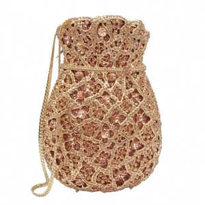 Detail of rose gold evening clutch with sparkling crystals and gold chain strap
