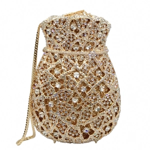 Detailed close-up of a drawstring gold evening bag with luxury crystal rhinestones