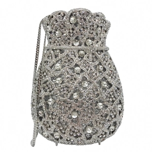 Macro shot of silver evening clutch bag featuring intricate hollow metal work and rhinestones
