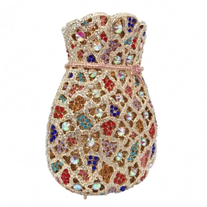 Close-up of drawstring evening bag with multicolor rhinestones and gold metal mesh