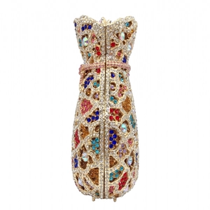 Close-up of sparkling colorful rhinestones on a gold hollow evening clutch bag