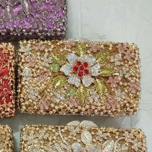 Detailed view of hollow metal evening clutch bags with sparkling floral crystal patterns