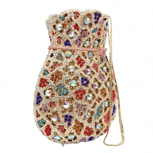 Macro detail of multicolored rhinestone floral pattern on a gold-framed evening clutch bag