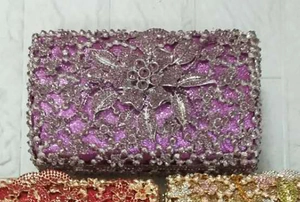 Detailed view of purple evening clutch featuring floral rhinestone patterns and metal hardware