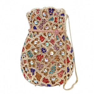 Macro detail of multicolored crystals on golden hollow-out evening clutch bag with chain