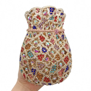 Detail view of gold money-pouch clutch bag with multi-colored crystals and intricate patterns