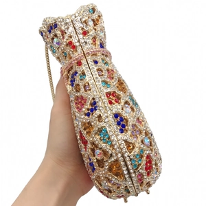 Detailed close-up of colorful rhinestones on a luxury gold evening clutch bag