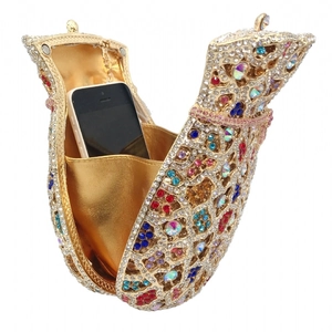 Detail view of colorful rhinestone evening bag showing interior space with a smartphone