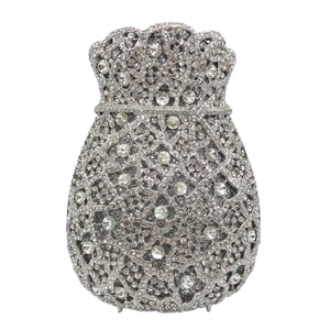Close-up of silver drawstring evening bag with intricate hollow patterns and crystals