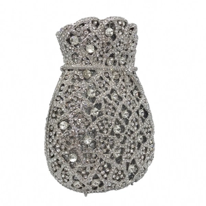 Detailed view of silver evening bag with dense sparkling rhinestone bag drawstring closure