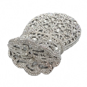 Macro shot of silver evening bag showcasing intricate hollow metal frame and dense rhinestones
