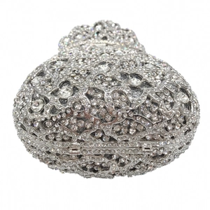 Close-up of heart-shaped silver clutch bag with intricate rhinestones and crystals