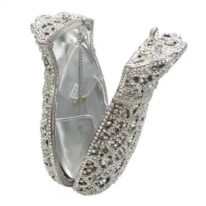 Detail view of silver rhinestone clutch showing sparkling lining and metal chain strap