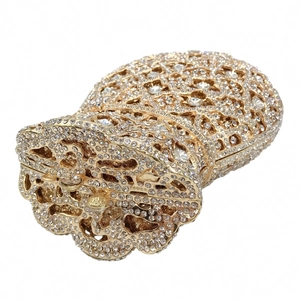 Detailed view of luxury evening clutch with gold-tone mesh and sparkling rhinestones