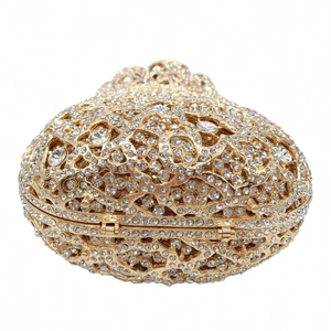 Detailed view of heart-shaped luxury evening bag with gold hollow frame and crystals