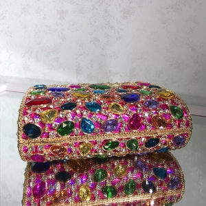 Close-up of vibrant multi-colored gems and sparkling rhinestones on an evening clutch bag