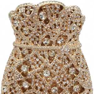 Close-up of golden drawstring pouch evening bag with intricate hollow metal and rhinestones