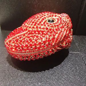 Macro shot of a red fox-shaped evening clutch bag with sparkling crystal rhinestones