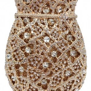 Close-up detail of luxury evening bag showing hollow floral patterns and dense rhinestones