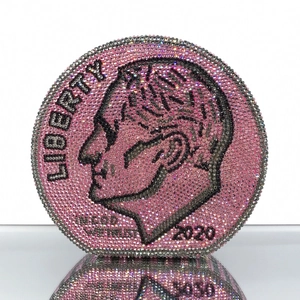 Close-up of pink crystal evening bag with detailed silver coin pattern and rhinestone surface