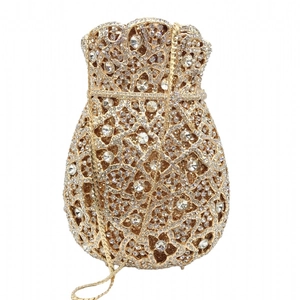 Macro shot of gold evening bag with drawstring style and sparkling crystal rhinestones