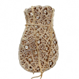 Detailed close-up of golden money pouch evening bag with sparkling crystal rhinestones