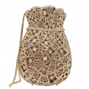 Close-up of gold hollow evening bag with sparkling crystal rhinestones and metal chain