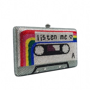 Macro detail of retro cassette tape clutch bag featuring glittering crystals and listen me text