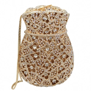 Detail of drawstring evening bag with gold floral patterns and encrusted white rhinestones