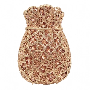 Macro shot of champagne gold evening clutch with crystal rhinestones and hollow metal frame