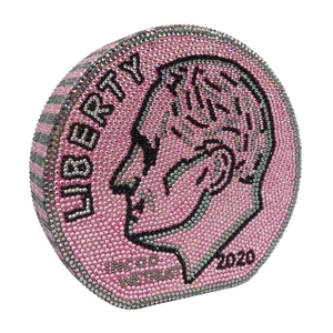 Macro detail of a round coin-shaped evening bag with pink and silver crystals