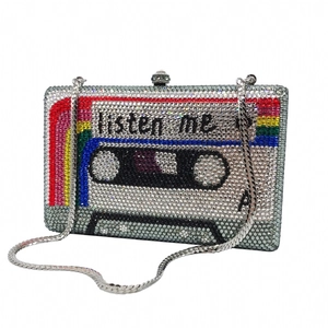 Macro shot of cassette-shaped evening clutch with silver crystals and rainbow stripes
