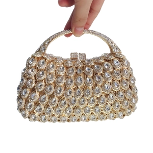 Luxury gold evening clutch bag with sparkling crystal droplets and metal handle