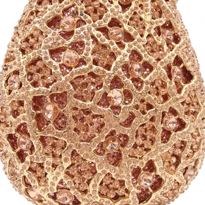 Macro shot of rose gold metal hollow pattern and crystals on luxury evening bag