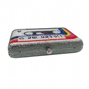 Detailed top view of a retro cassette tape clutch bag with sparkling rainbow rhinestones