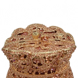 Detailed top view of champagne gold evening bag with rhinestones and spherical clasp