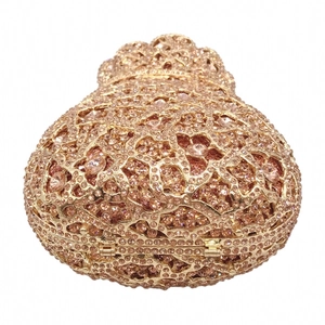 Detailed macro view of the intricate floral hollow-out metalwork and champagne rhinestones
