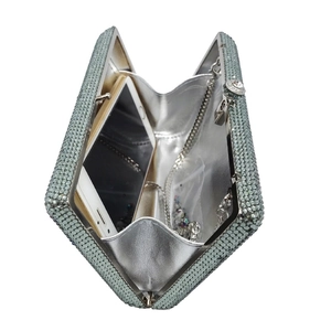 Internal view of crystal cassette clutch bag showing phone storage and silver lining